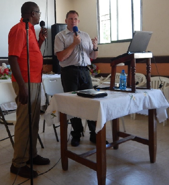 Rev. Jonathan Baird, right, speaks at Jacmel, Haiti, with interpreter Pastor Placide