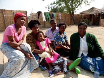 Church women meeting on mats in the yard of my host family
